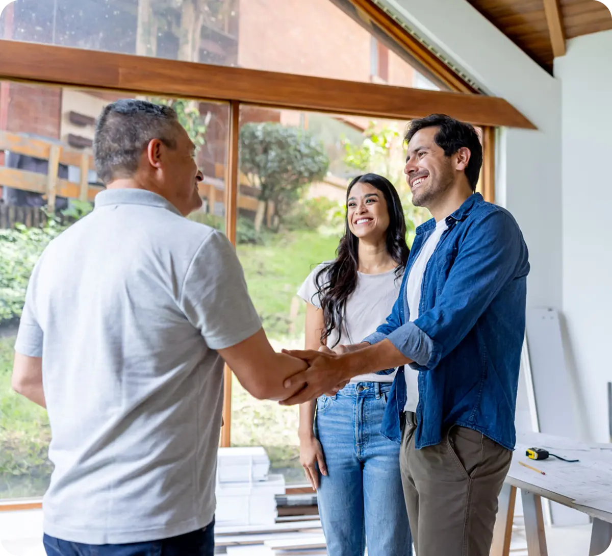 Real estate agent handshake with couple
